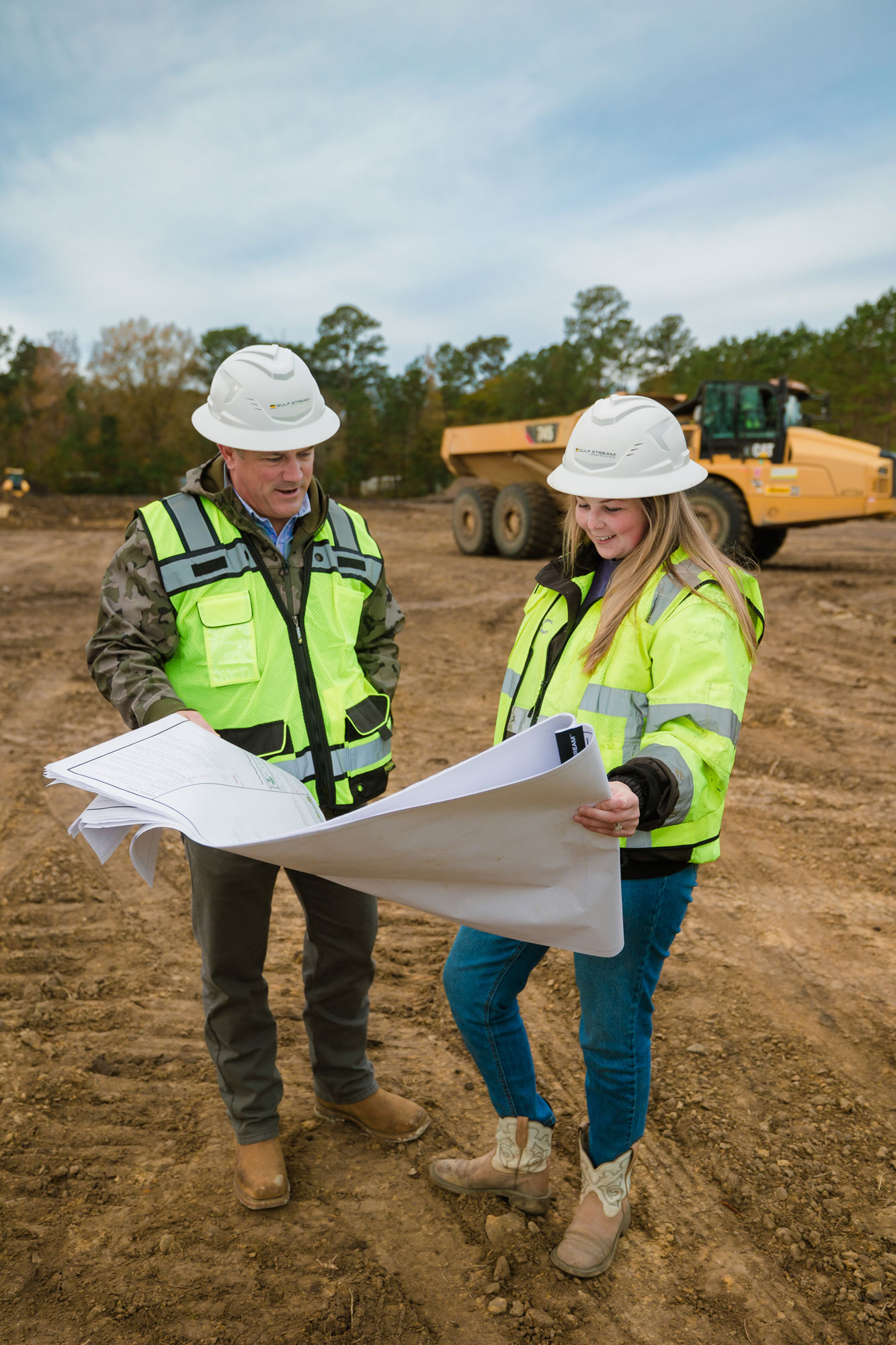 Construction workers reviewing plans on-site