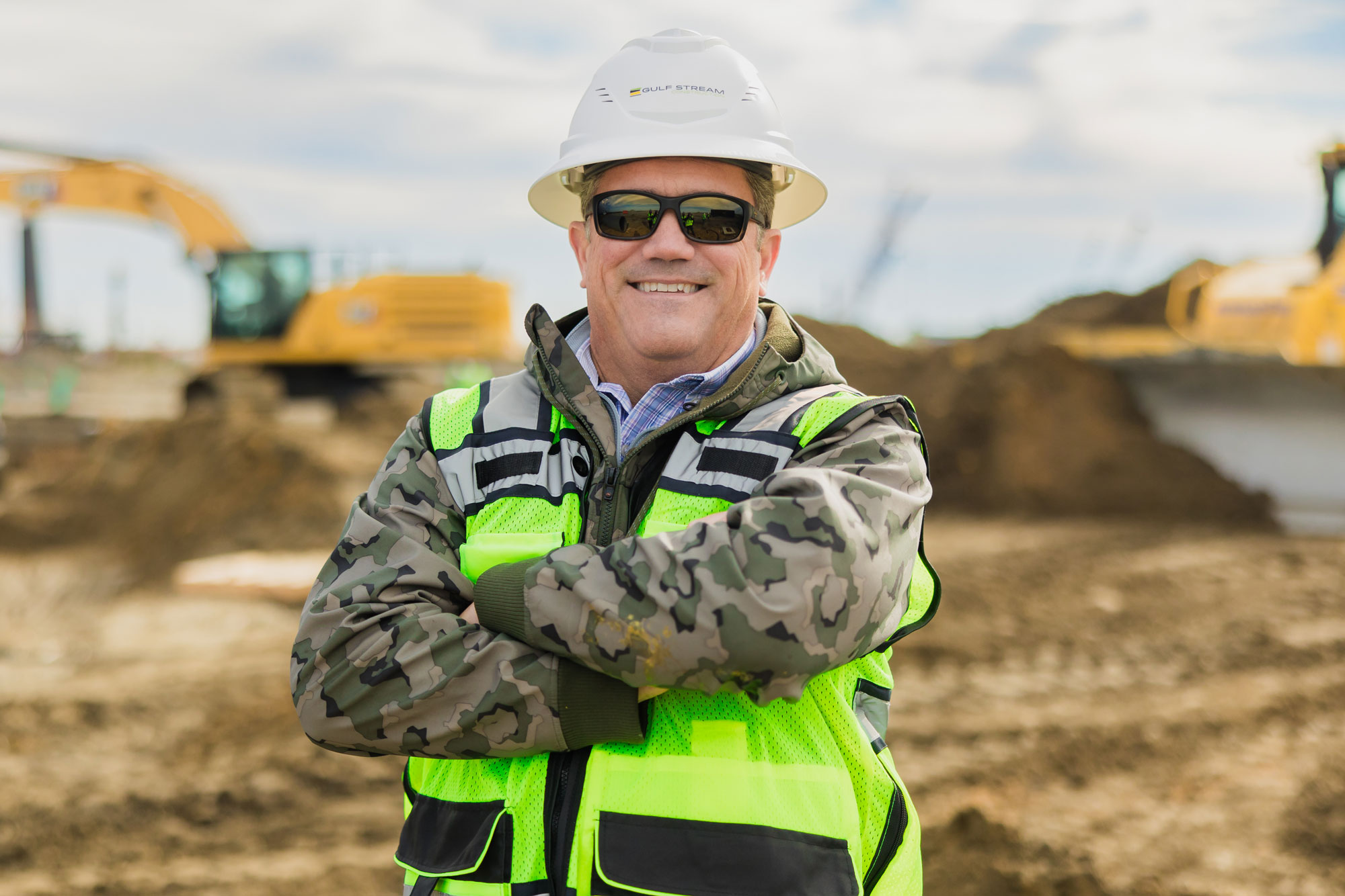 Mark Hylton smiling with arms crossed in construction zone