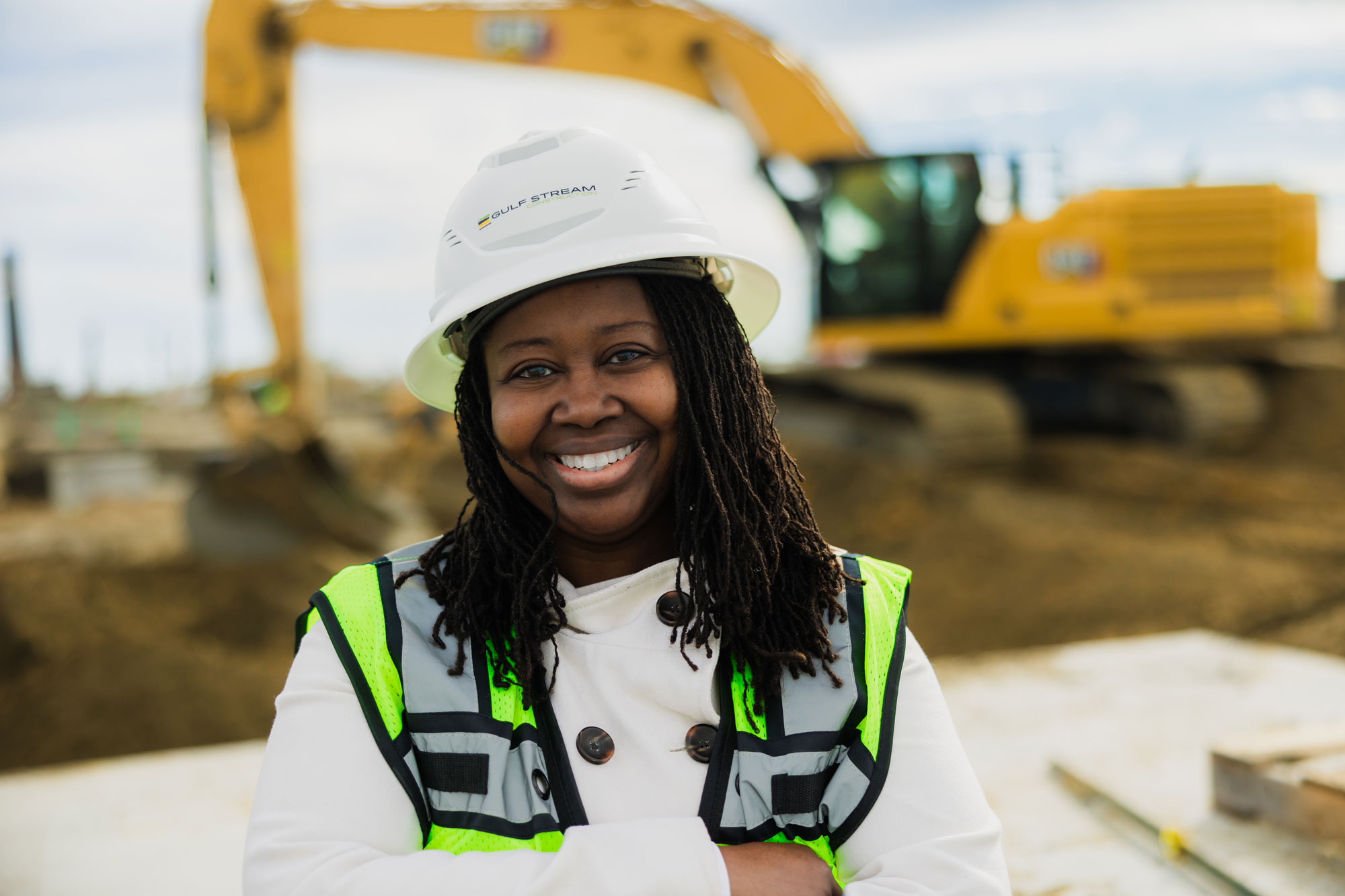 Shere Hills smiling with arms crossed in construction zone