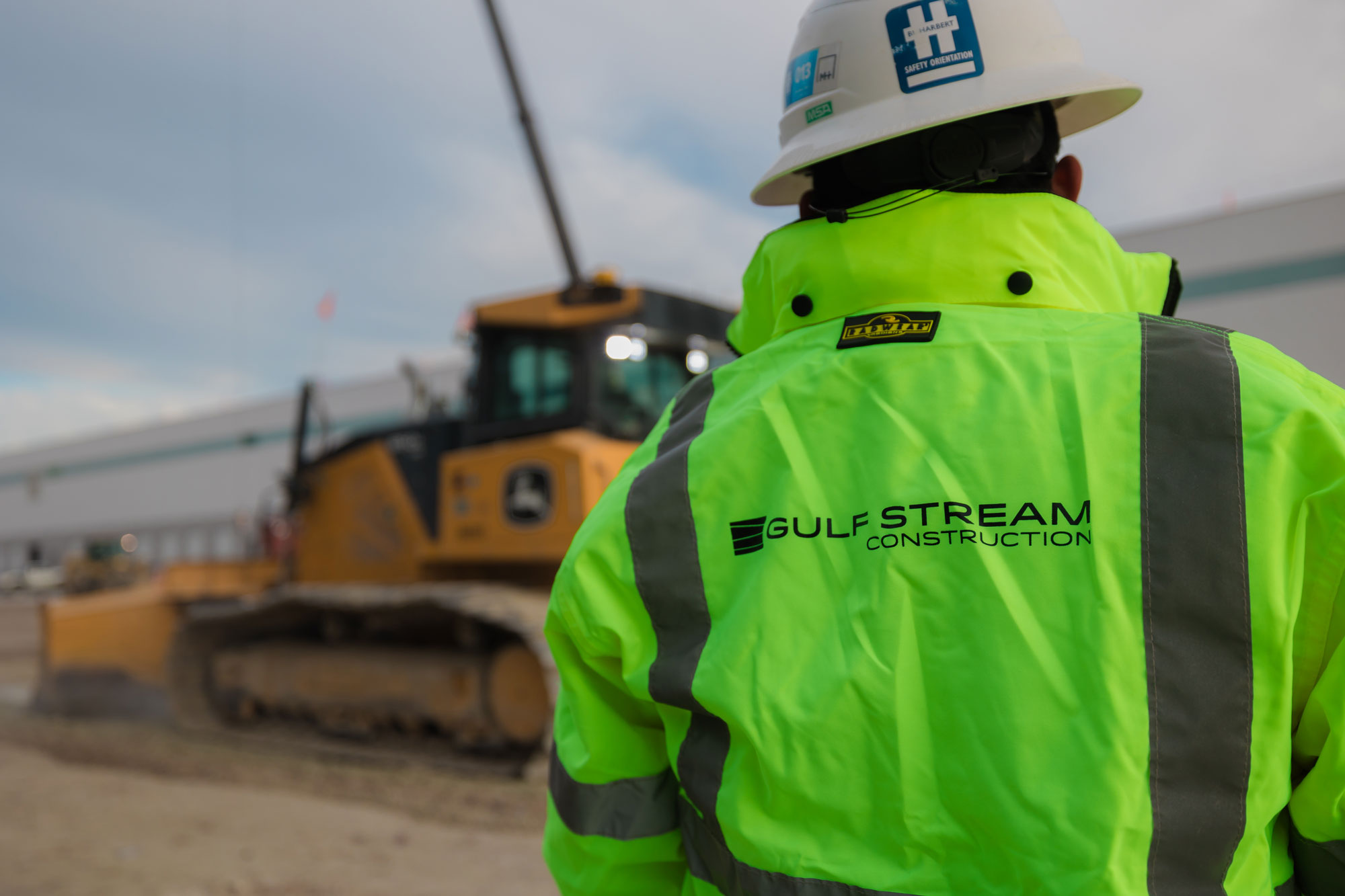 Construction worker wearing Gulf Stream Construction jacket