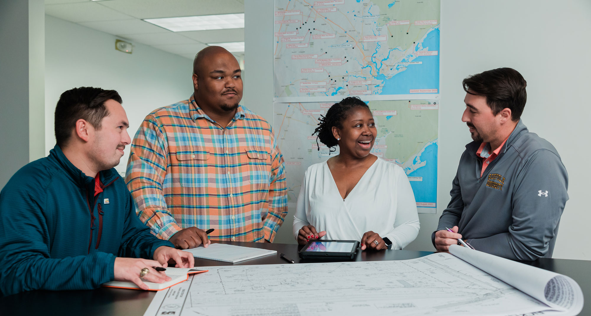 Gulf Stream Construction team members conversing in office setting